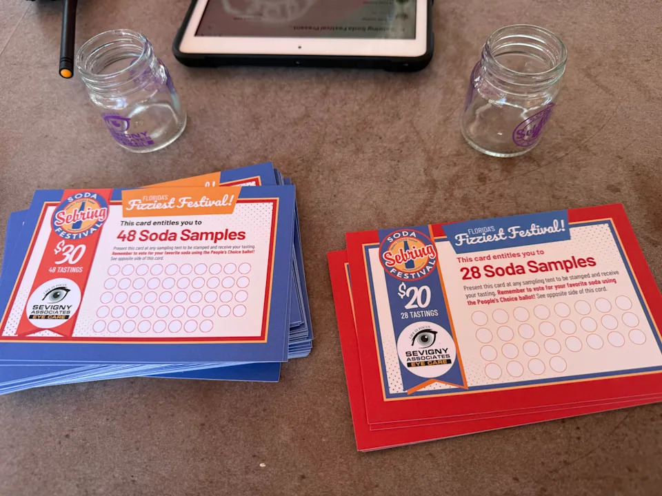 Two cards and two glasses on a table.
