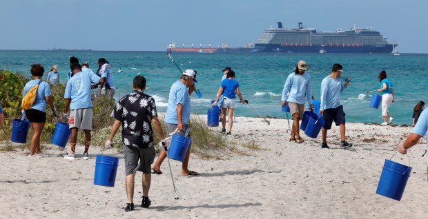 Dozens of volunteers take part in cleaning up Dania beach on Monday, April 21, 2025. Lucky Fish Beach Bar & Grill and the City of Dania Beach joined forces to Commemorate Earth Day with Fifth Annual Beach Clean-Up. (Carline Jean/South Florida Sun Sentinel)