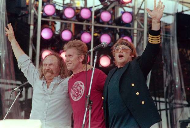 FILE - From left, David Crosby, Graham Nash and Stephen Stills, performing collectively as Crosby, Stills and Nash, acknowledge the crowd during the Live Aid concert for famine relief at JFK Stadium in Philadelphia, Pa. July 13, 1985.(AP Photo/Amy Sancetta)