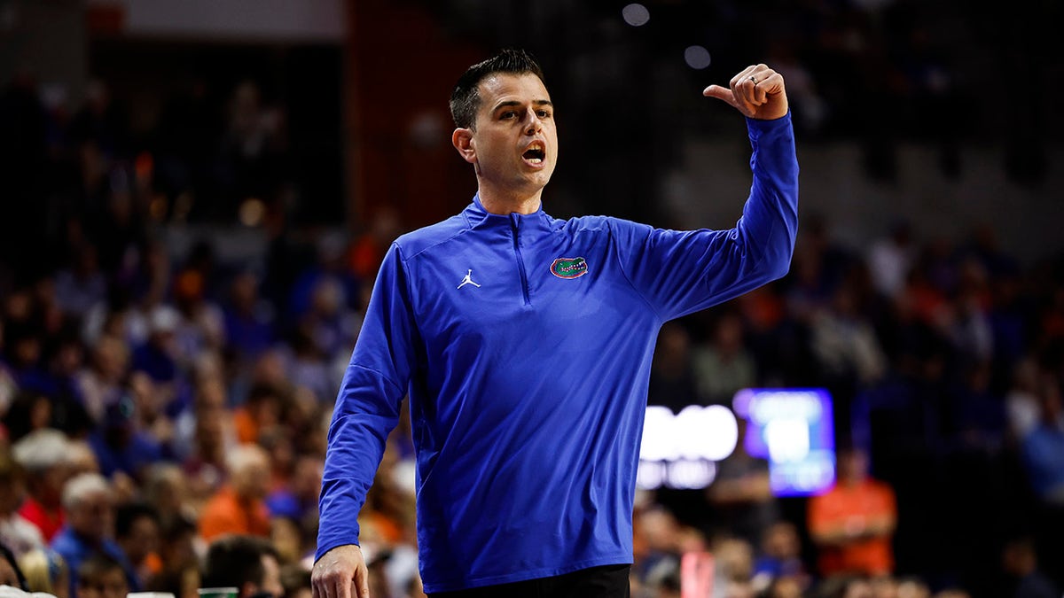 Head coach Todd Golden of the Florida Gators reacting on the bench during a basketball game.