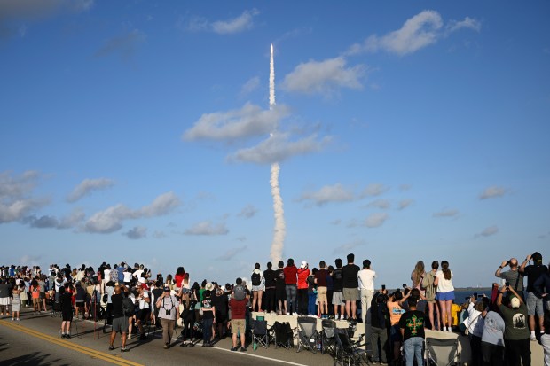 Spectators look on from the A. Max Brewer Bridge as NASA's Artemis II moon rocket lifts off Wednesday, April 1, 2026, as seen from Titusville, Fla. (AP Photo/Phelan M. Ebenhack)