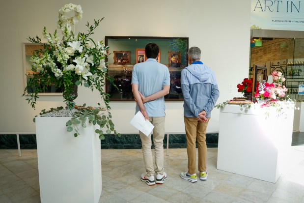 Art and flowers share attention in the galleries of the Orlando Museum of Art during Art in Bloom, the annual Council of 101 floral-inspired event and fundraiser, on Friday, April 10, 2026. (Rich Pope/Orlando Sentinel)