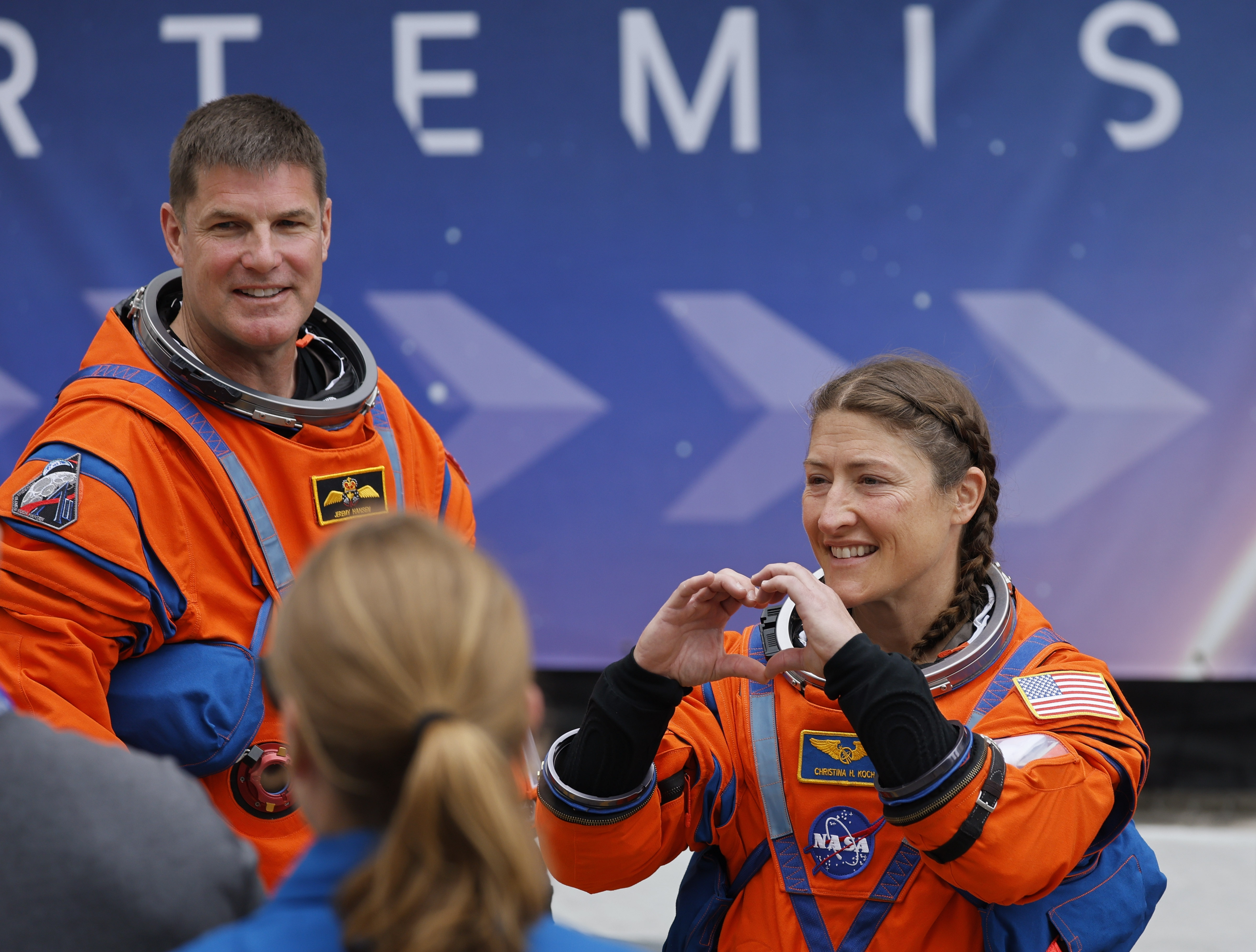 Artemis II mission specialists Jeremy Hansen and Christina Koch walk...