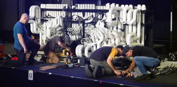 Left to Right, Zachary Olson, head of automation department; Daniel Pooley, head of carpentry; Kevin Connolly, head of the musical instrument department; and musical instrument technician Bruno Ufret work on the pvc during a media tour of the new Blue Man Theater, on Thursday, April 16, 2026. Blue Man Group shows are scheduled to start on May 1, 2026, at ICON Park. (Ricardo Ramirez Buxeda/ Orlando Sentinel)