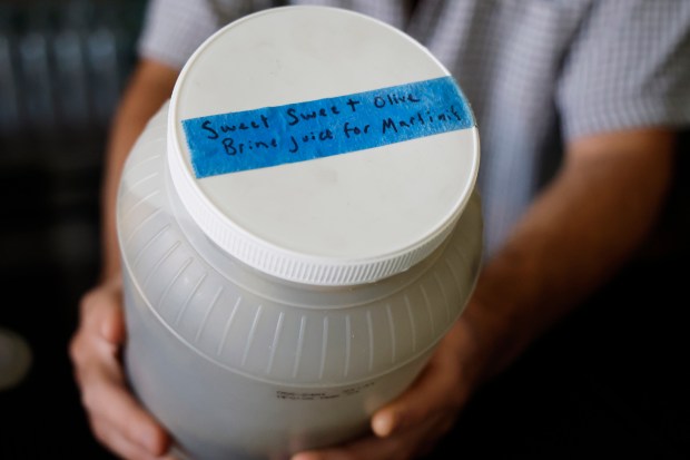 Leo Rees shows off their house-made brine at d.b.a., a Mills 50 bar. (Ricardo Ramirez Buxeda/ Orlando Sentinel)
