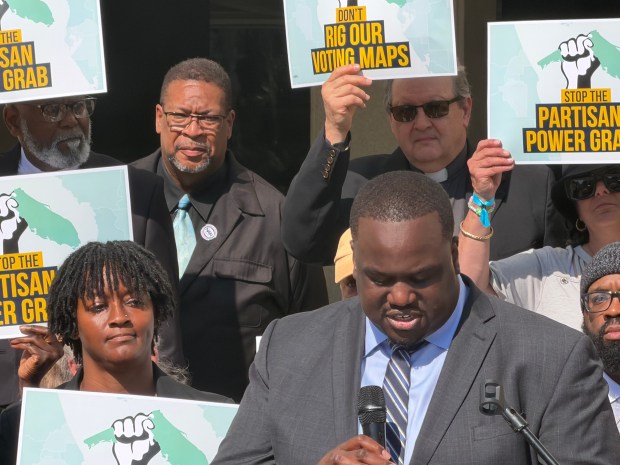 Genesis Robinson, cofounder of Equal Ground, speaks to a crowd of protestors gathered at the State Capitol on Tuesday, April 28, 2026. About 200 showed up on the opening day of a special session to protest the new redistricting map by Gov. Ron DeSantis that eliminates four Democratic seats, including a Hispanic-majority seat in Osceola County. (Jeffrey Schweers/Orlando Sentinel)