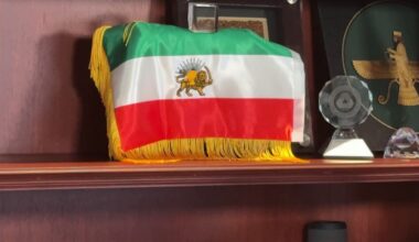 A lion and sun flag sits in the office of former Iranian America Community Center President Pooyan Balouchian. (Spectrum News)