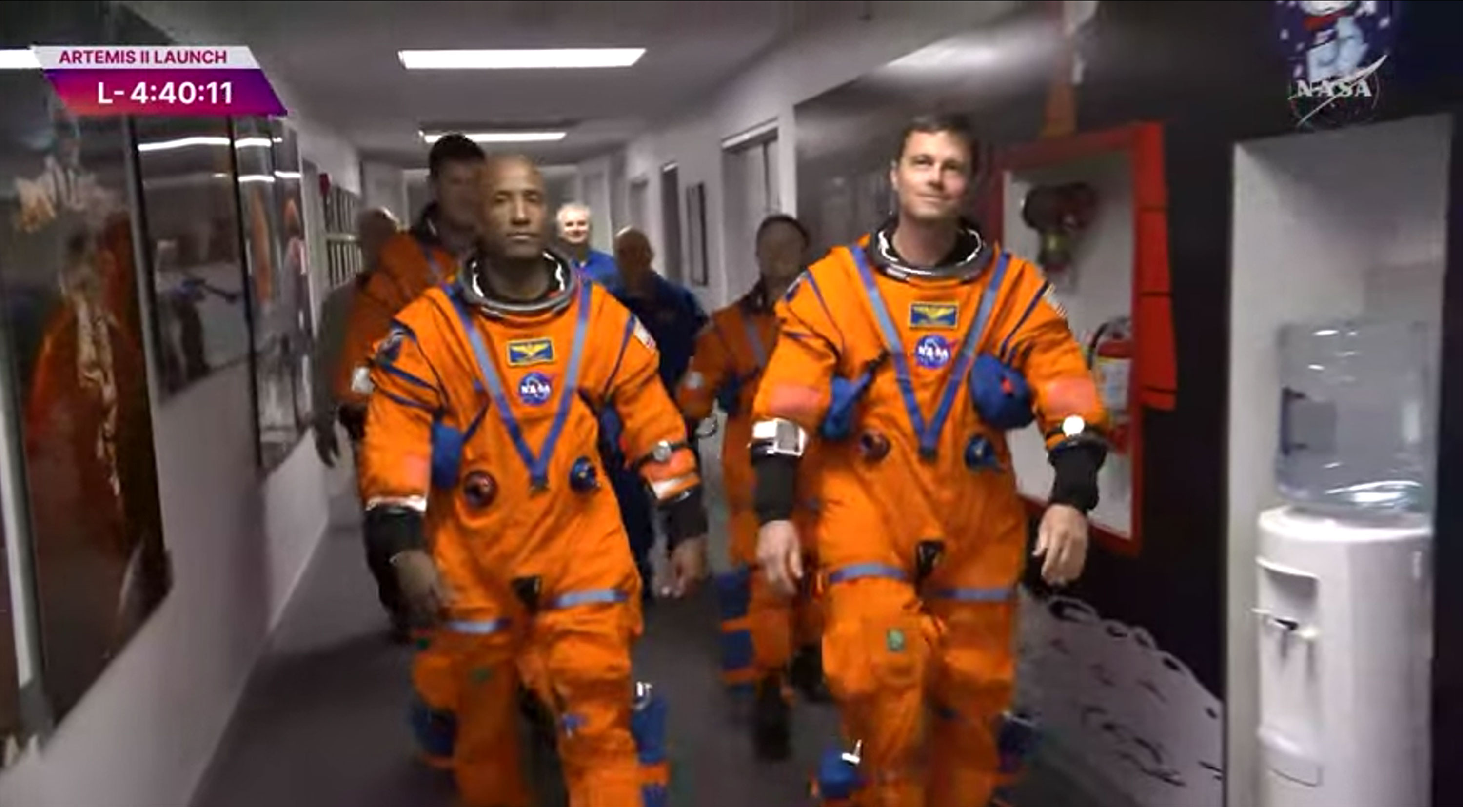 The four Artemis II astronauts make their way outside the...