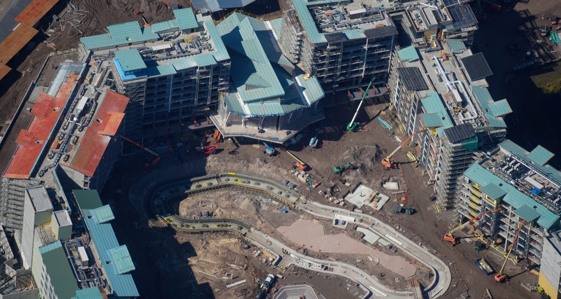 An aerial photo by bioreconstruct shows the lobby of Disney Lakeshore Lodge that overlooks the lazy river. Concrete was recently poured for the loop of the river.
