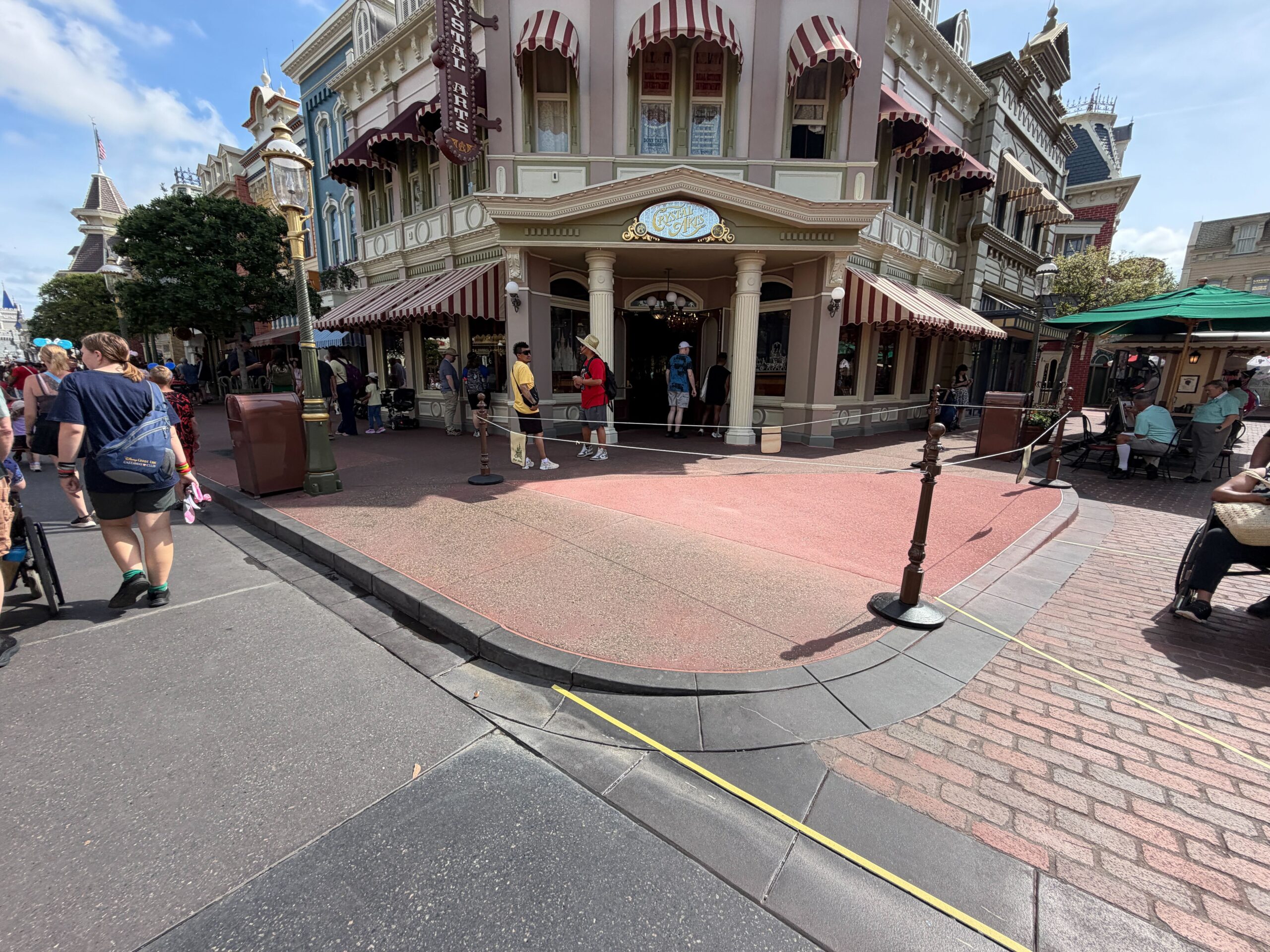 The pavement work that began three weeks ago outside Crystal Arts in Magic Kingdom appears to be complete. Since construction began, a large patch of pavement was covered by temporary wood boards.