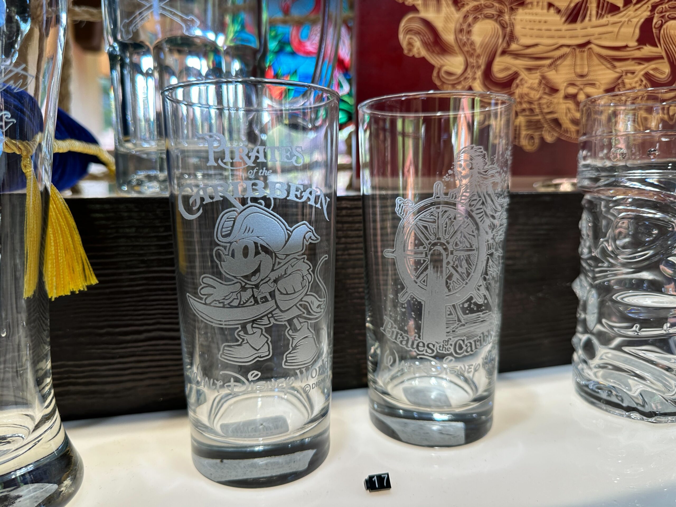 Pirate Mickey is on one glass with the Pirates of the Caribbean and Walt Disney World wordmarks.