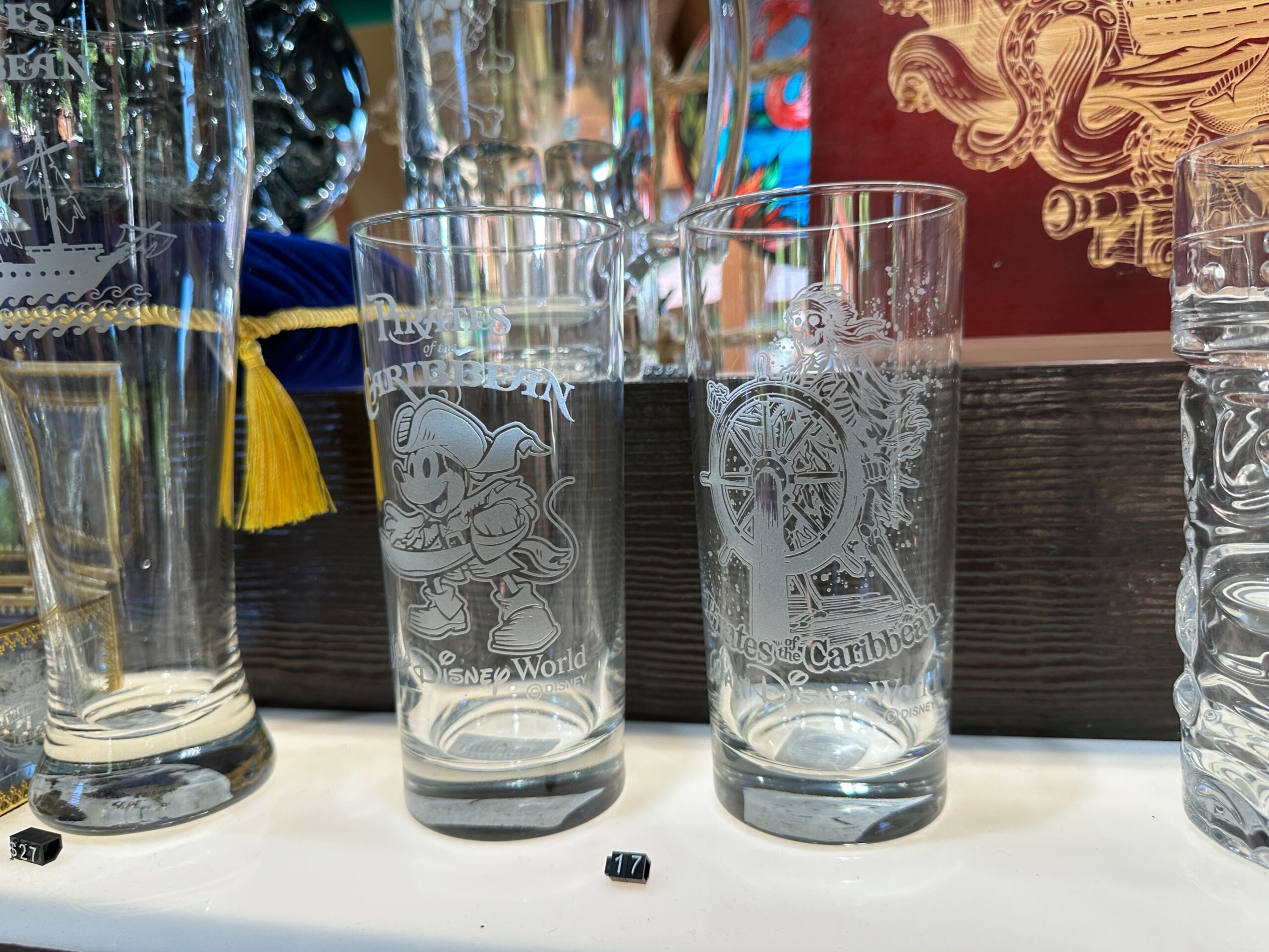 The famous pirate skeleton at the ship's wheel is pictured on another tall glass.