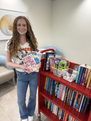 Hooters team members delivering books and activities to cancer patients