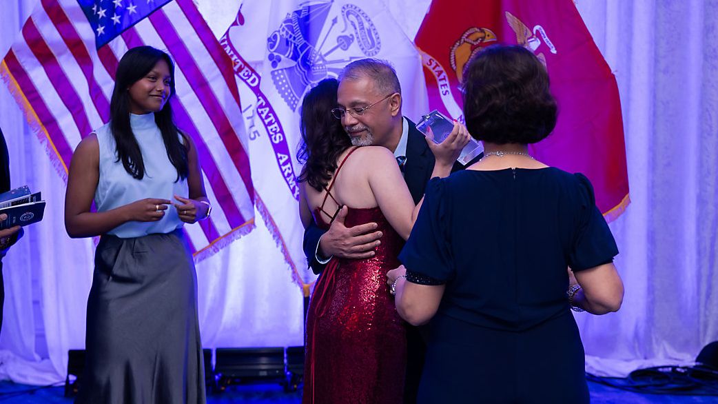 Amani Ambay hugs her father, Raj, after receiving the Operation Homefront Military Child of the Year Award. (Photo: Operation Homefront)