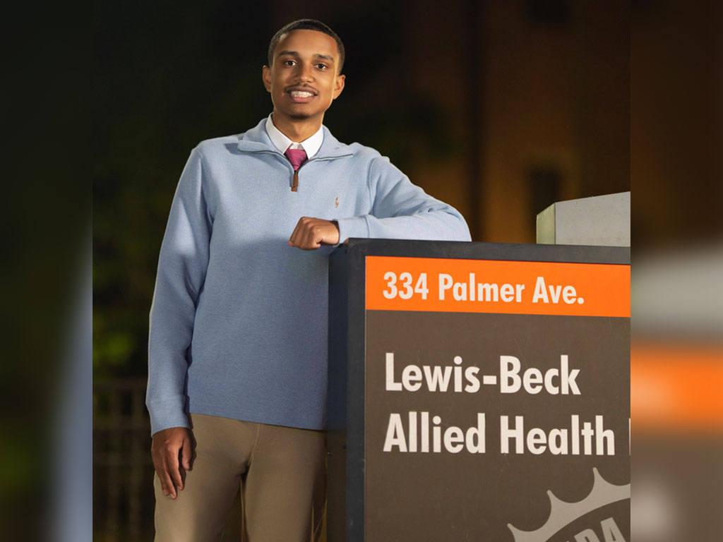 Florida A&M University graduate Ian Tibbs poses outside the Lewis-Beck Allied Health Building, reflecting the academic journey that helped prepare him for a career in health care and graduate studies. (Photo courtesy: Ian Tibbs)