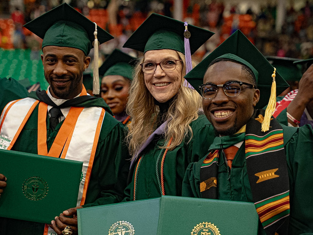 We did it! Graduates smiling in the crowd.
