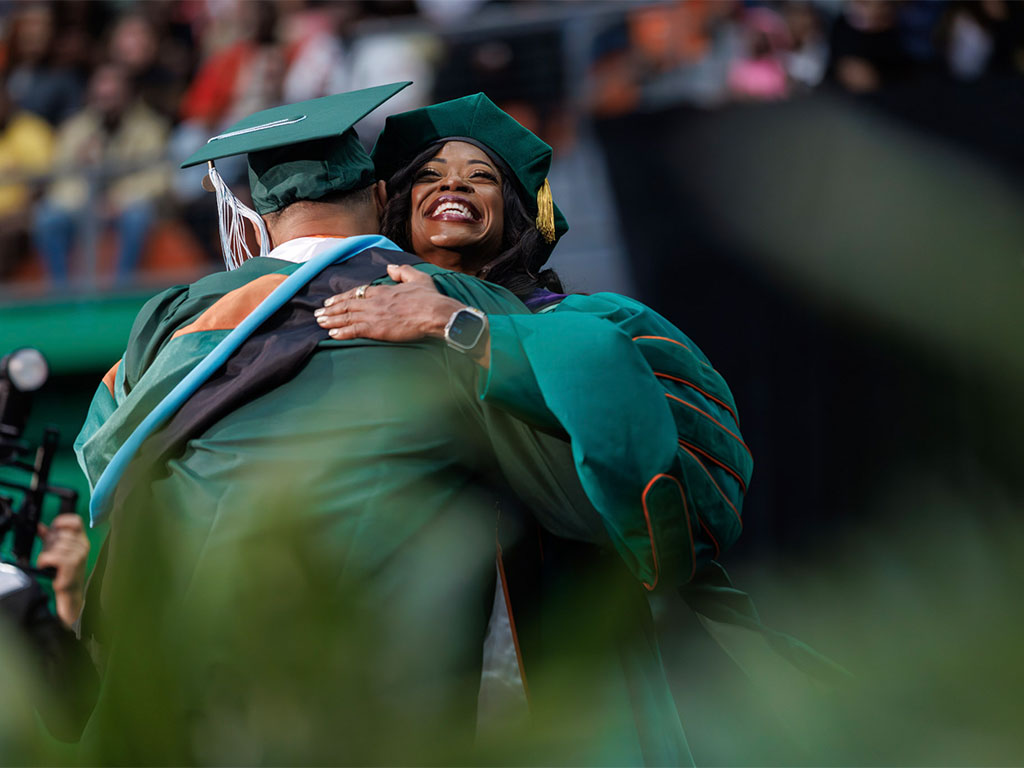 President Johnson embracing student at graduation