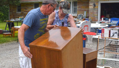 Brother and sister David West and Karol Hill set down a heavy cabinet ahead of the 2024 city-wide yard sale. The deadline to participate as a seller in this year's sale is May 8.