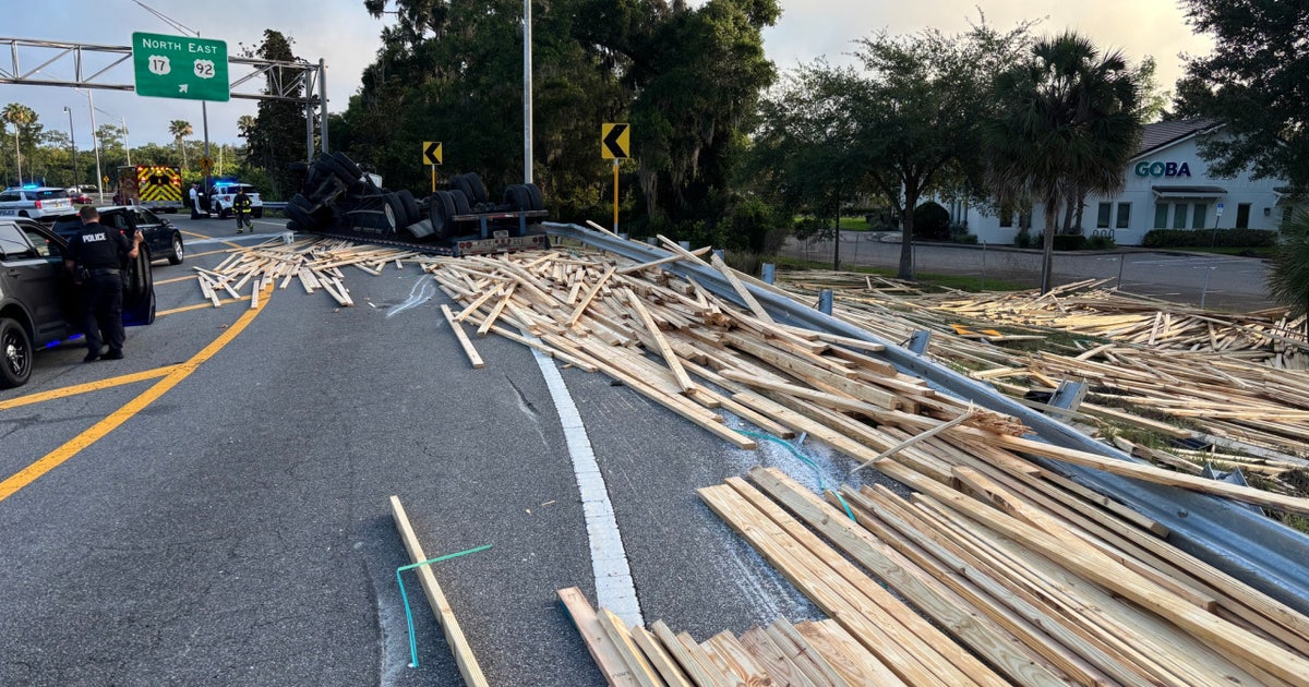 Tractor-trailer overturns, spills lumber onto Maitland road