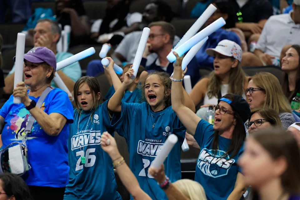 Jacksonville Waves fans cheer during the third quarter of an UpShot League women’s basketball game at VyStar Veterans Memorial Arena, Friday, May 15, 2026. in Jacksonville, Fla. Tonight marked the first home Waves game for the inaugural UpShot women’s professional basketball season. The Charlotte Crown held off the Jacksonville Waves 103-95.