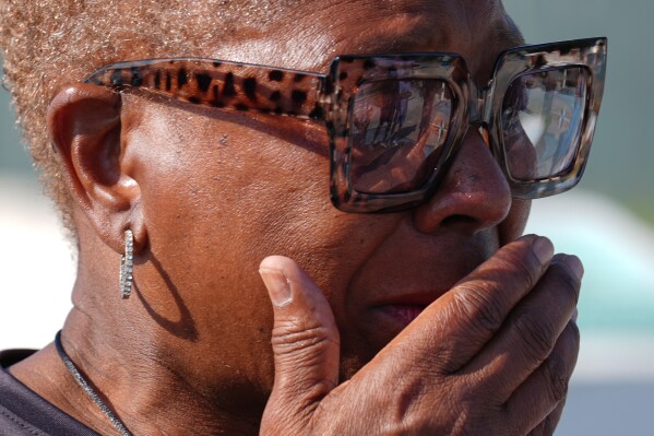 Underwater Adventure Seekers member Ruthie Browning reacts with emotion after pouring a libation of white rum onto the sand, on the site where hundreds of Africans who died in 1860 after being rescued from three slave ships were buried, on Higgs Beach in Key West, Fla., Saturday, May 9, 2026. (AP Photo/Rebecca Blackwell)