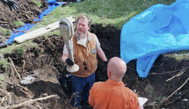 Kale Schleiter (left) holds a parking meter as he and city employee John Green pull the contents from a time capsule on the downtown Jacksonville square. The time capsule, sealed in 1975 as part of the city's sesquicentennial celebrations, was opened in 2025 as part of the city's bicentennial celebrations. A new time capsule will be buried next week.