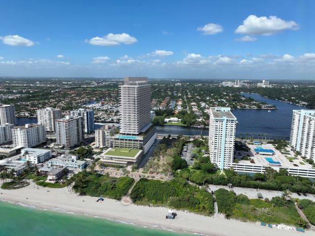 An artist's illustration shows a luxury condo tower with workforce housing apartments planned on public land at 1301 South Ocean Drive. The parcel is now home to a community center and Harry Berry Park in Hollywood. (SOM/CFE/ARX, Courtesy)
