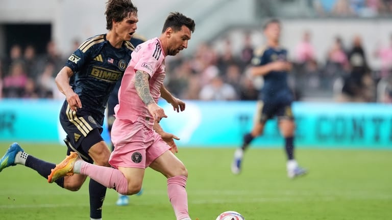 Inter Miami forward Lionel Messi (10) drives downfield under pressure...