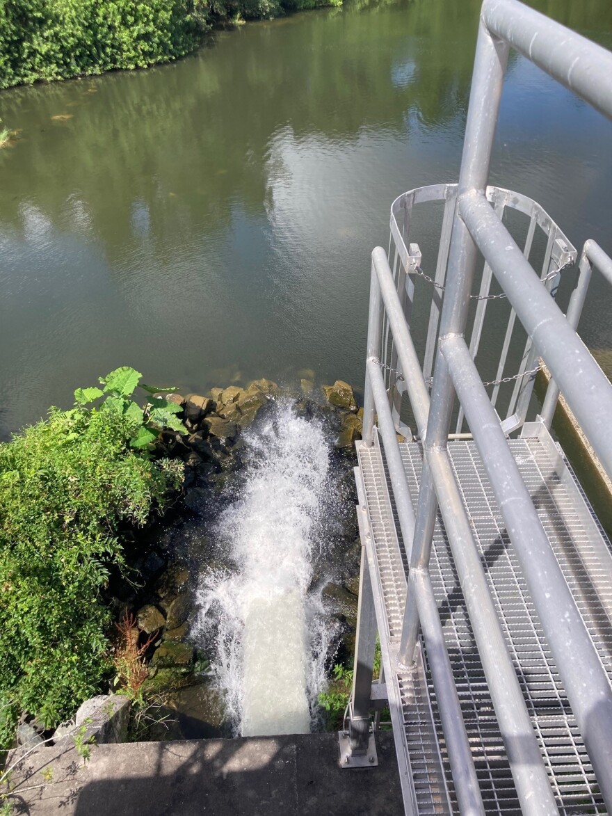 water flowing under a dam