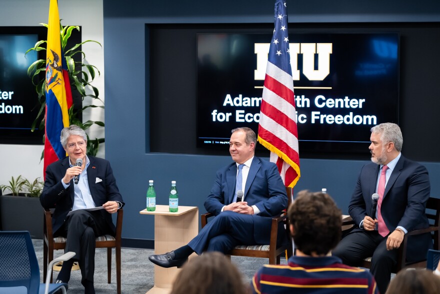 Former Ecuadorian president Guillermo Lasso speaks with Carlos Diaz-Rosillo and former Colombian president Ivan Duque at an event in March of 2024.
