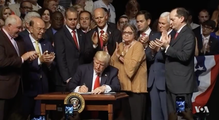 President Trump signed new sanctions on Cuba in 2019. Surrounding him are Adam Smith Center Founding director Carlos Diaz-Rosillo, then his advisor; Sen. Rick Scott, Rep. Mario Diaz-Balart; then-Sen. and current Secretary of State Marco Rubio, Vice PResident Mike Pence, and Alexander Acosta the then-Labor Secretary.