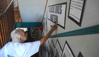Ruth Linear, founding director of the Jacksonville African American History Museum, touches a sign that says "Black Lives Matter." Linear has contributed much of the research at the museum.