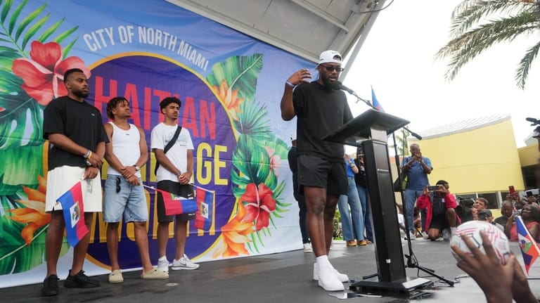 Haiti national soccer team striker Duckens Nazon, right, speaks as...