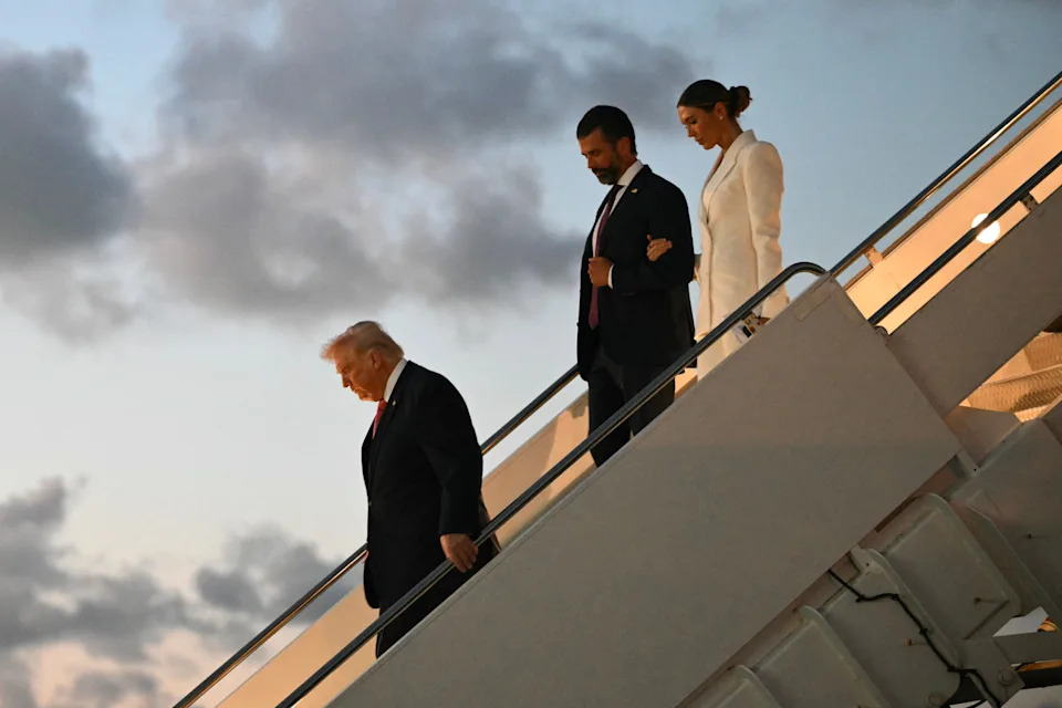 President Donald Trump, Donald Trump Jr. and Bettina Anderson step off Air Force One upon arrival at Palm Beach International Airport in West Palm Beach, Florida on March 27, 2026.