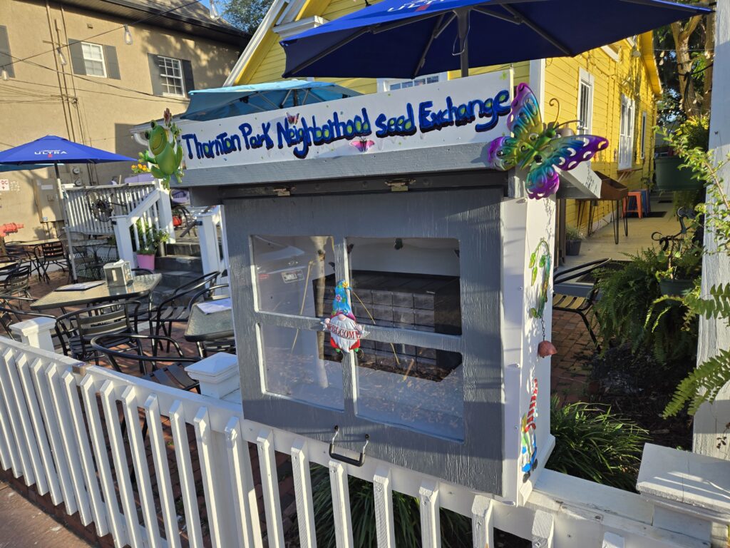 a cabinet outside on a fence with seeds in it
