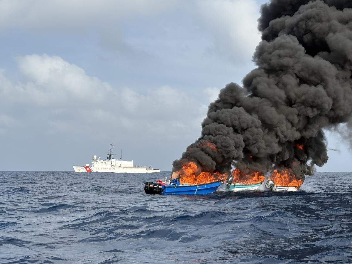 Three suspected cocaine-smuggling boats are in flames with the U.S. Coast Guard Cutter Tahoma seen in the background off the coast of Colombia on Friday, May 8, 2026.