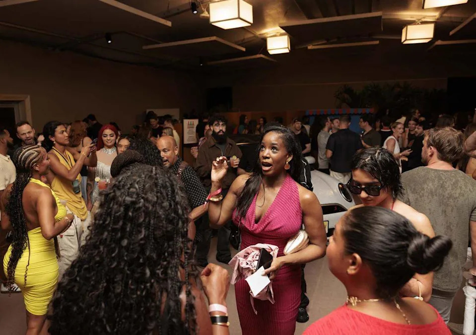 People talk in the pre-show area before the Hot Girl Summer Paraiso Miami Swim Week Runway Show on Thursday, May 28, 2026, on Collins Avenue in Miami Beach. 