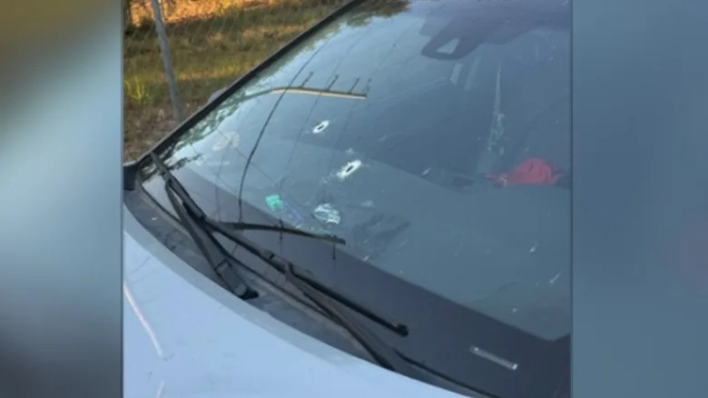 Bullet holes through the windshield of an SUV that was the victim of a road rage incident