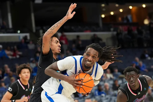 Memphis' Aaron Bradshaw (11) looks to pass the ball as Florida Atlantic's Devin Williams (1) guards him during the game between the University of Memphis and FAU at FedExForum in Memphis, Tenn., on January 29, 2026.