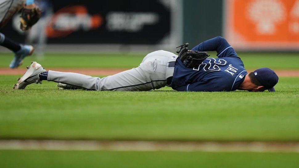 Tampa Bay Rays starting pitcher Griffin Jax (22) reacts after an injury during the second inning of a baseball game against the Baltimore Orioles, Tuesday, May 26, 2026, in Baltimore. (AP Photo/Stephanie Scarbrough)