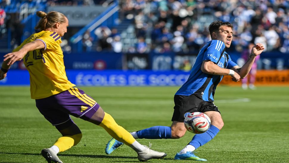 CF Montreal's Luca Petrasso, right, reacts as Orlando City's Griffin Dorsey, left, clears the ball from the box during first-half MLS soccer match action in Montreal, Saturday, May 9, 2026. (Graham Hughes/The Canadian Press via AP)