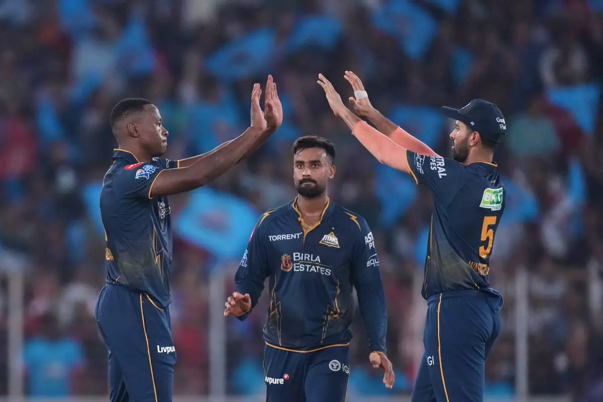 Gujarat Titans' Kagiso Rabada, left, celebrates the wicket of Punjab Kings' Suryansh Shedge with teammates during the Indian Premier League cricket match between Gujarat Titans and Punjab Kings in Ahmedabad, India, Sunday, May 3, 2026. (AP Photo/Ajit Solanki)