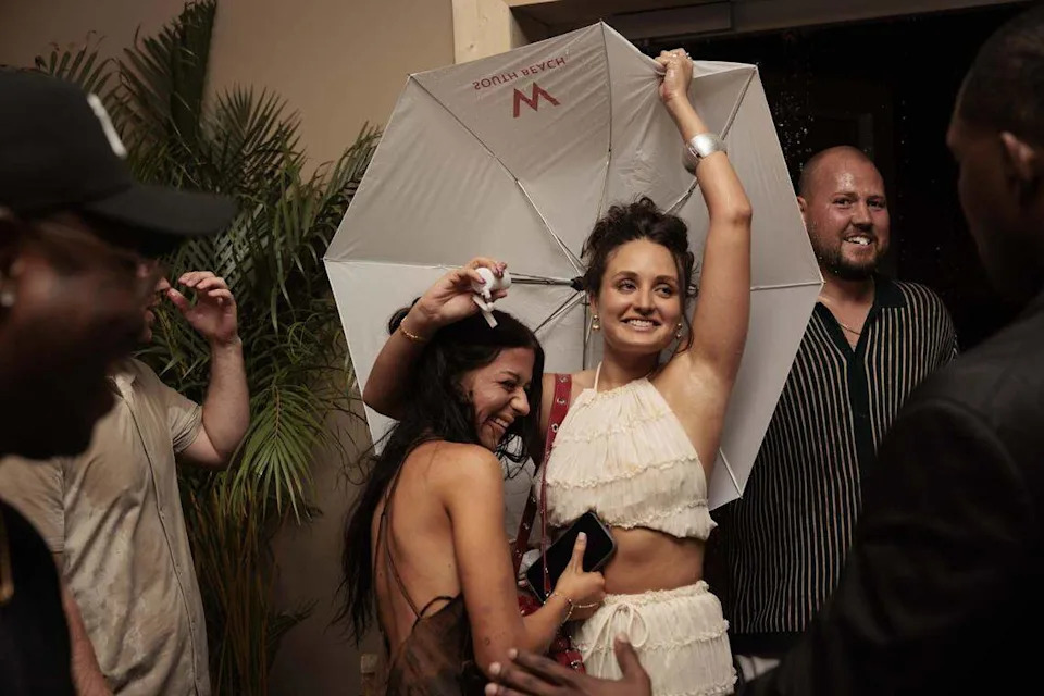 People come in from the storm before the Hot Girl Summer Paraiso Miami Swim Week Runway Show on Thursday, May 28, 2026, on Collins Avenue in Miami Beach, Fla. (Miami Herald photojournalists were restricted from covering the actual runway show).