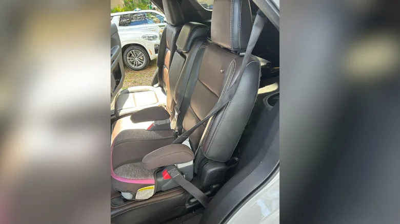 The victim's back seat with a bullet hole where a child was sitting in a booster seat