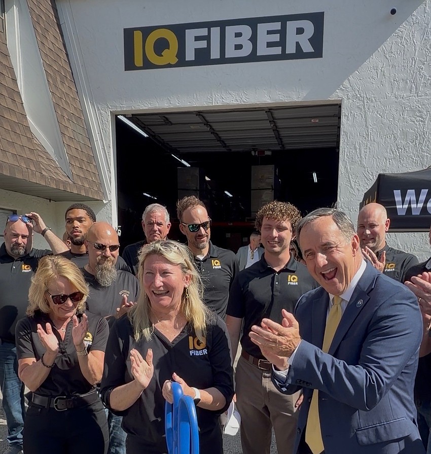(Left to right) IQ Fiber's Vice President of PMO and Integrations Patti Lewis and CMO Kim Smithers celebrates the opening of the company's Clearwater office with Clearwater Mayor Bruce Rector.