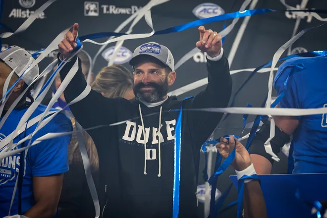 CHARLOTTE, NORTH CAROLINA - DECEMBER 06: Head Coach Manny Diaz of the Duke Blue Devils celebrates after the 2025 ACC Football Championship against the Virginia Cavaliers at Bank of America Stadium on December 06, 2025 in Charlotte, North Carolina. (Photo by David Jensen/Getty Images)