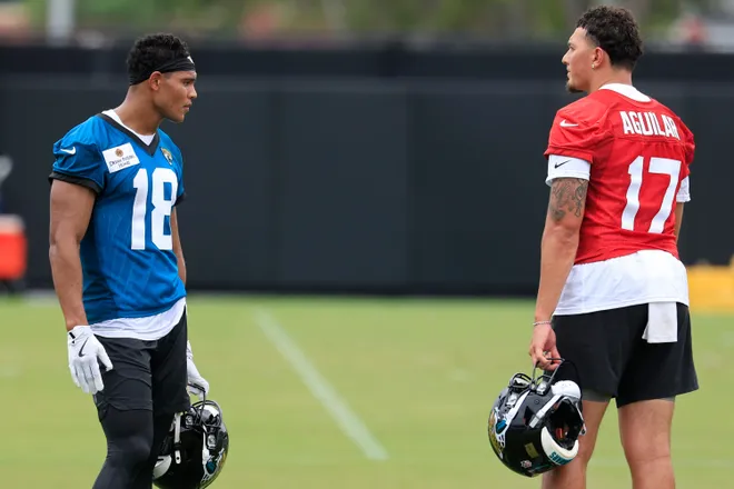 Jacksonville Jaguars wide receiver CJ Williams (18), left and quarterback Joey Aguilar (17) talk during rookie minicamp at the Miller Electric Center, Saturday, May 9, 2026 in Jacksonville, Fla. Today was the second of a three day camp concluding Sunday.