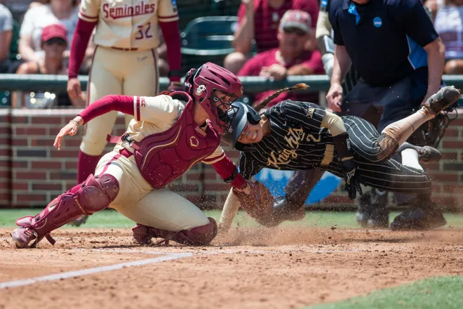 Florida State Seminoles catcher Madi Frey (24) tries to tag UCF Knights infielder Samantha Rey (2) as she dives into home plate. The Florida State Seminoles defeated the UCF Knights 2-1 in their first game on Sunday, May 17, 2026.