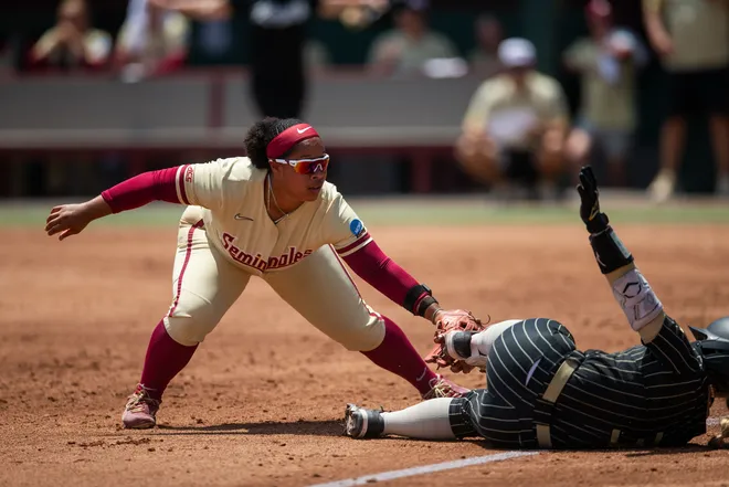 Florida State Seminoles infielder Jaysoni Beachum (42) tries to tag the runner as they dive into third base. The Florida State Seminoles defeated the UCF Knights 2-1 on Sunday, May 17, 2026. The teams must play one more game to determine the NCAA Tallahassee regional winner.