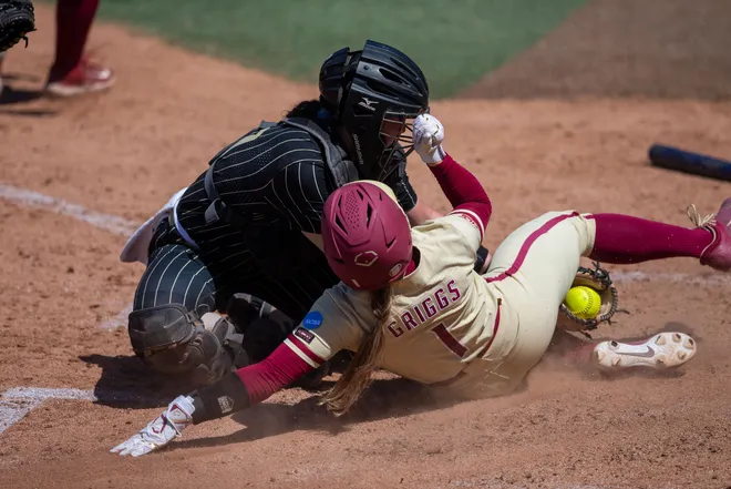 Florida State Seminoles utility player Hayley Griggs (1) slides into home — the run would be removed after a challenge from the UCF coach showed another player was caught leaving base early. The UCF Knights defeated the Florida State Seminoles 4-2 in the final game of the NCAA Tallahassee regional finals Sunday, May 17, 2026.